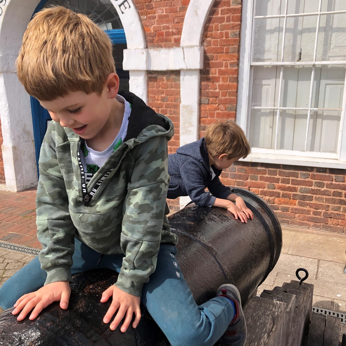 Aaron's two sons climbing and playing on a cannon