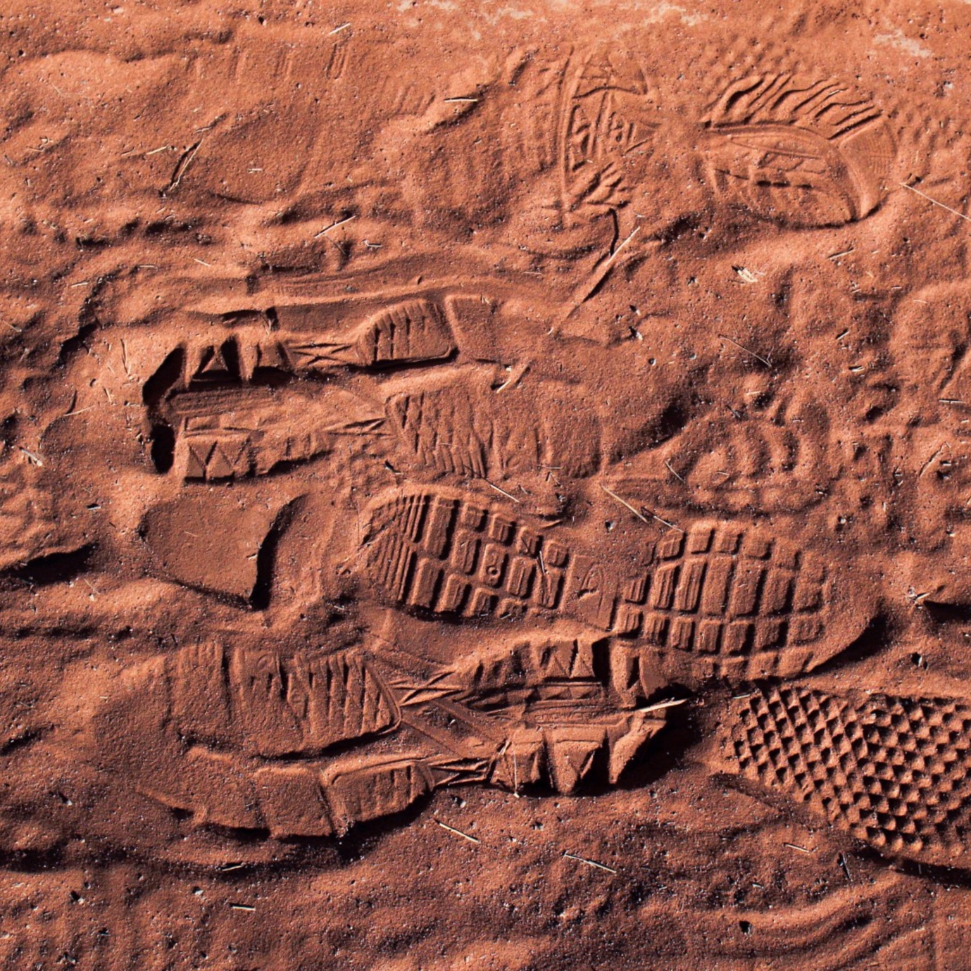 Overlapping footprints in red dirt